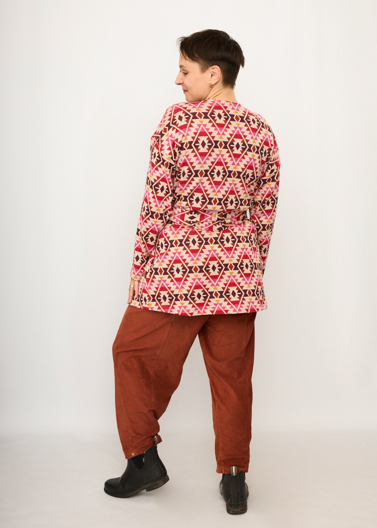 Melly trägt auf dem Foto 'Cora' Größe S, Muster elastisch, Jacquardstrick Pink-rot und 'Betty' Größe M, Velvet-Cord rostrot