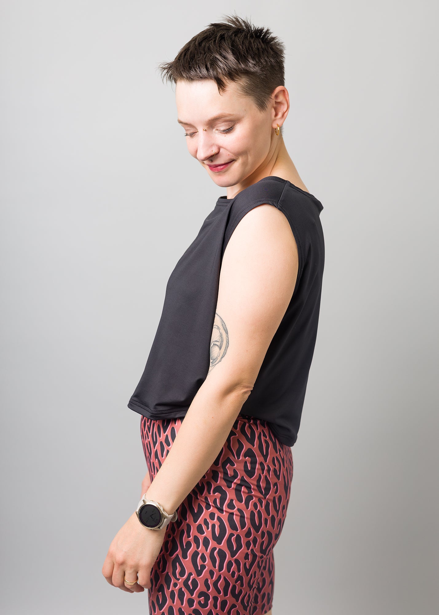 Melly trägt auf dem Foto 'Gerda' ohne Ärmel Größe S und 'Rea' Größe M, Funktionsstoff schwarz und 'Leo'