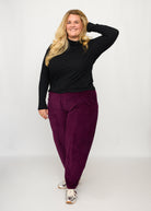 Nina trägt auf dem Foto 'Betty' Größe XXXL, Velvet-Cord aubergine und 'Rosalie' Größe XXXL, Rippjersey schwarz